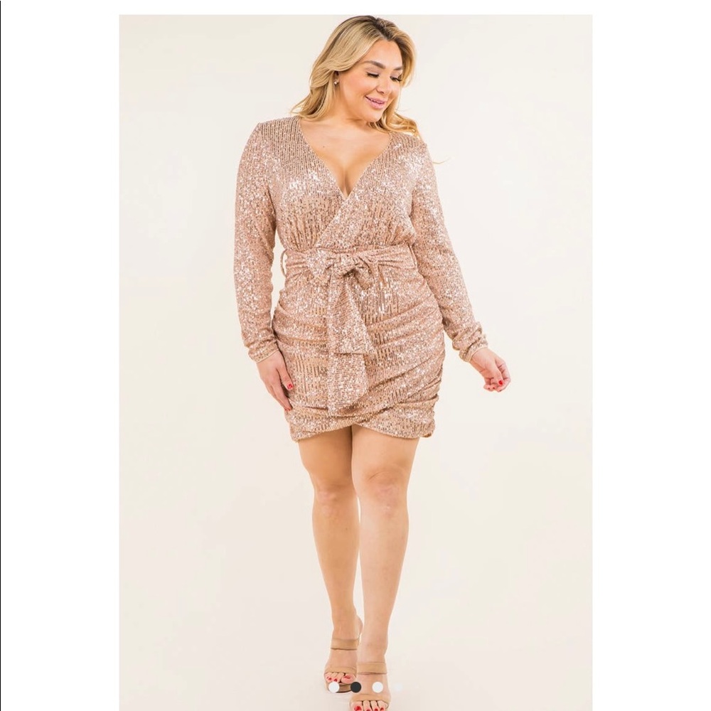 Sparkle in this curve loving dress with gathered waist and belt.